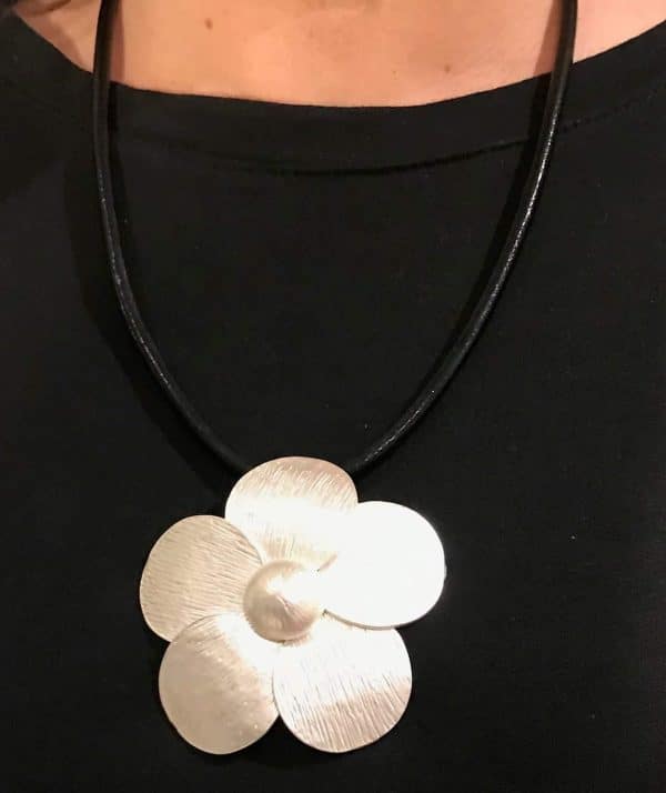 Matt silver flower pendant necklace.